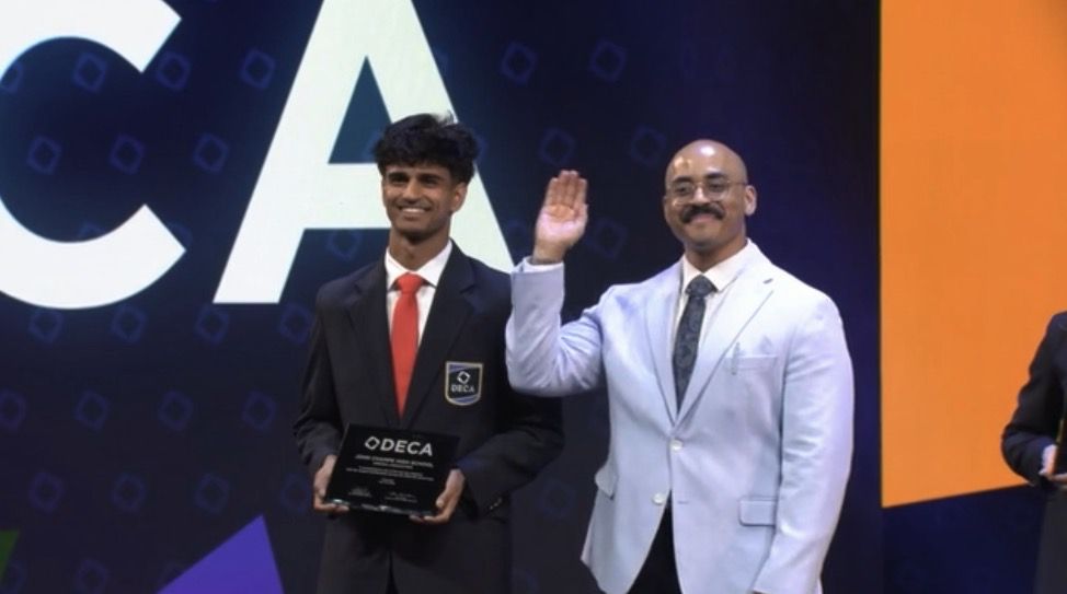 A member receiving an award on stage