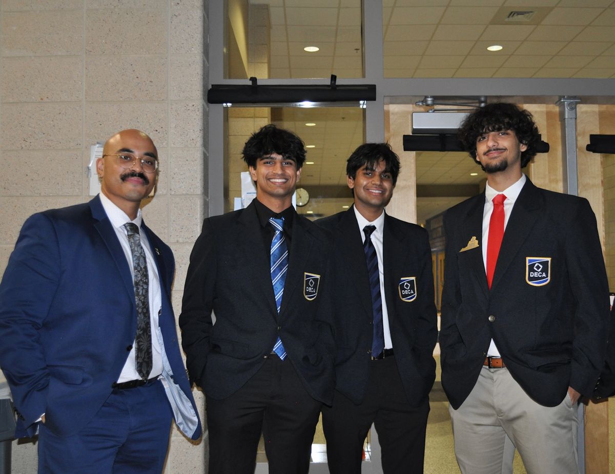 Chapter members with their advisor at a district conference